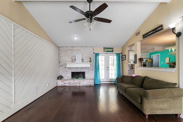 unfurnished living room featuring ceiling fan, dark hardwood / wood-style flooring, vaulted ceiling, and a brick fireplace