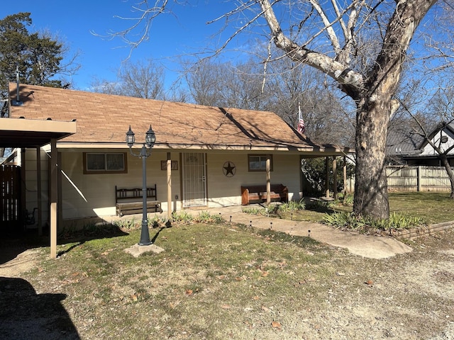 back of property with a yard and covered porch