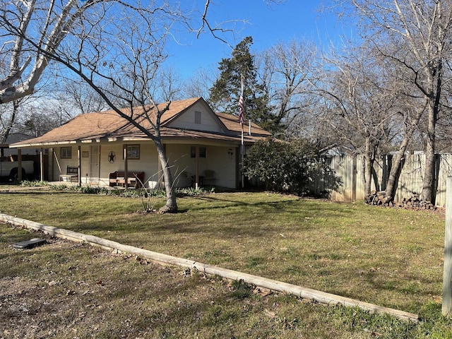 view of side of property featuring a yard