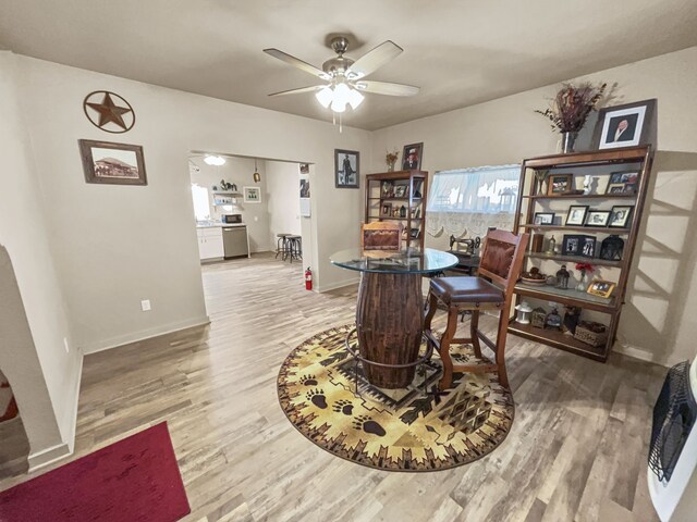 dining area featuring hardwood / wood-style flooring and ceiling fan