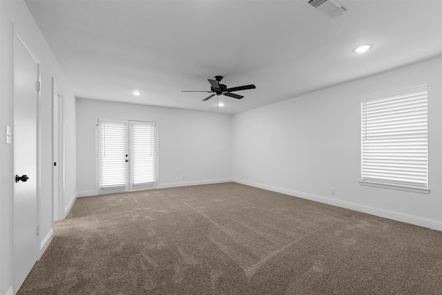 empty room with visible vents, baseboards, ceiling fan, carpet, and recessed lighting