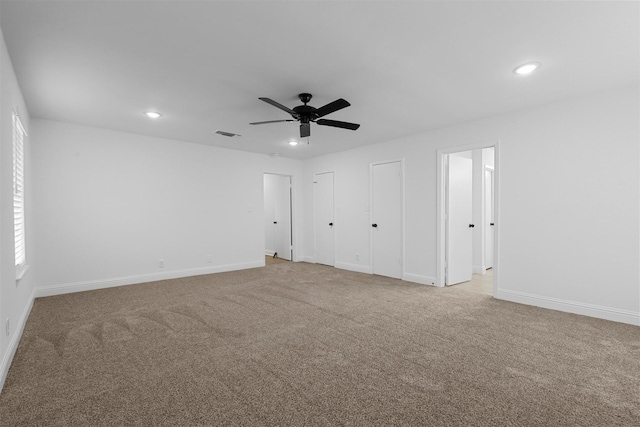 unfurnished room with recessed lighting, visible vents, and light colored carpet