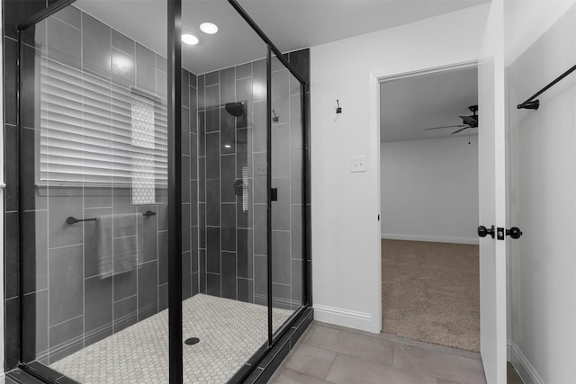 full bathroom featuring a shower stall, baseboards, a ceiling fan, and tile patterned floors