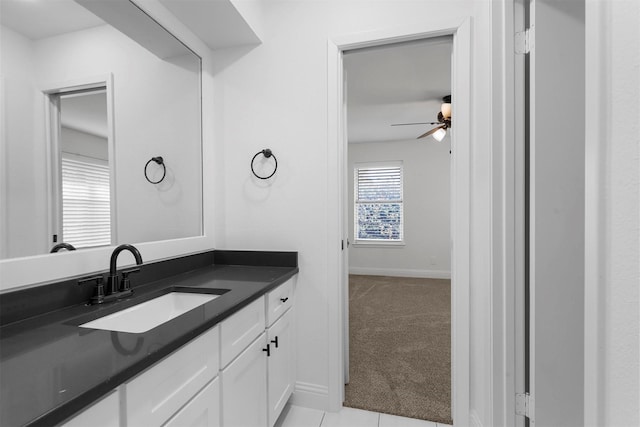 bathroom featuring vanity, a ceiling fan, and baseboards