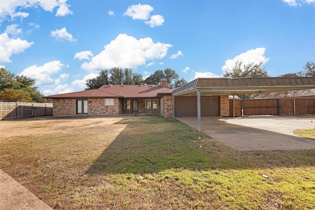 view of front of home with driveway, an attached garage, fence, a front yard, and brick siding