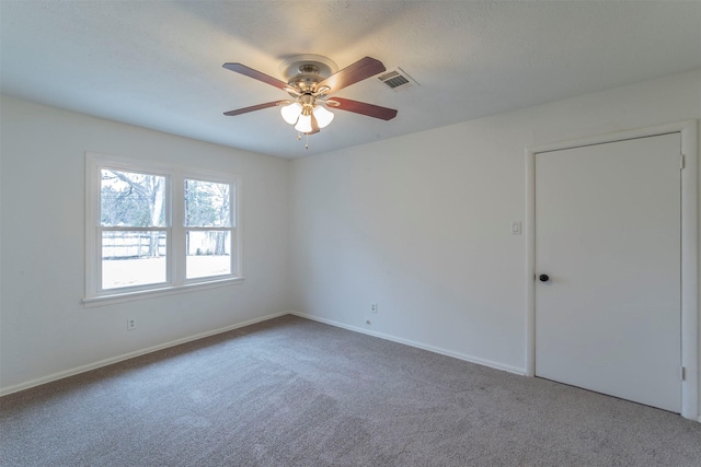 carpeted empty room featuring ceiling fan