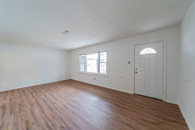 entryway with dark hardwood / wood-style flooring