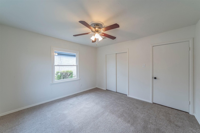 unfurnished bedroom featuring carpet floors, ceiling fan, and a closet