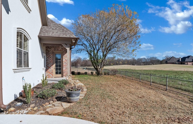 view of yard with a rural view