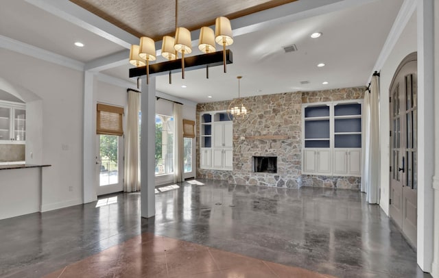 unfurnished living room featuring a notable chandelier, a stone fireplace, and ornamental molding