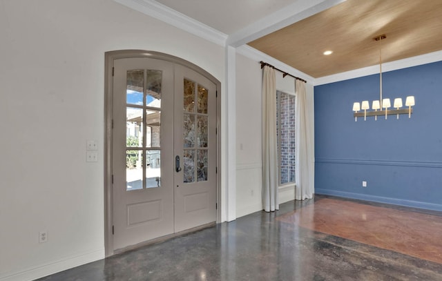 entrance foyer with french doors, ornamental molding, and an inviting chandelier