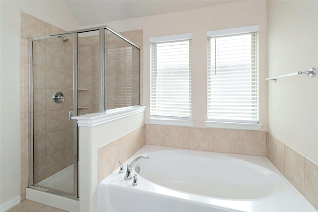 bathroom with vaulted ceiling, tile patterned floors, and independent shower and bath