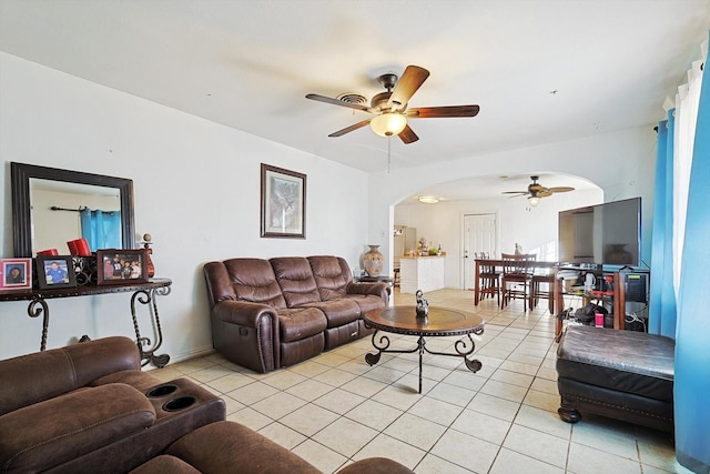 tiled living room featuring ceiling fan