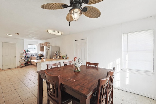 tiled dining area featuring ceiling fan