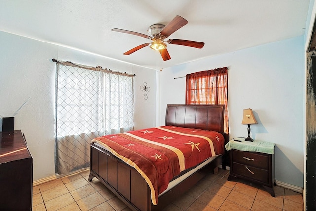 bedroom with ceiling fan and light tile patterned floors