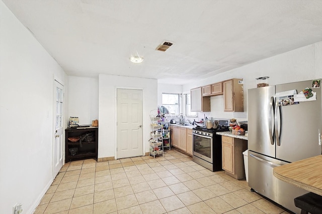 kitchen featuring light tile patterned floors, sink, and appliances with stainless steel finishes