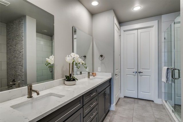 bathroom with vanity, tile patterned flooring, and a shower with shower door