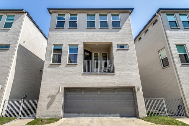 townhome / multi-family property featuring a garage and a balcony