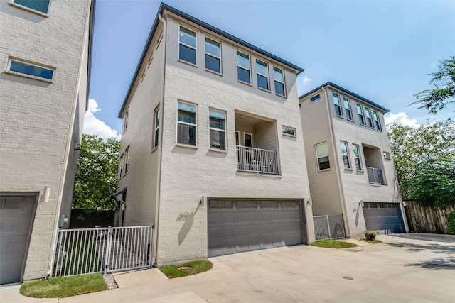 townhome / multi-family property featuring a garage and a balcony