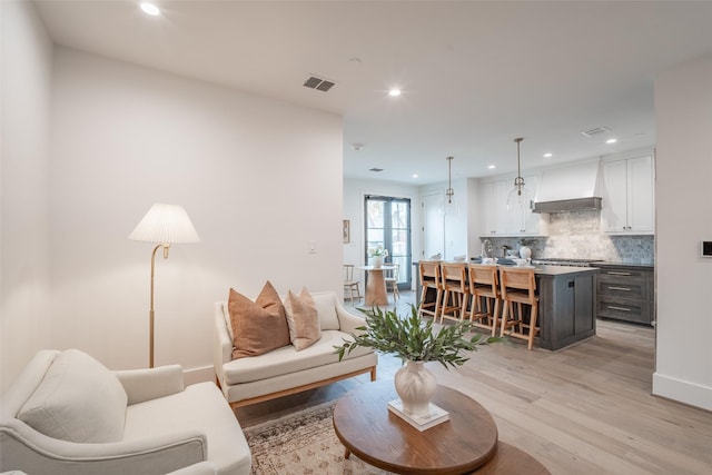 living room with light hardwood / wood-style flooring