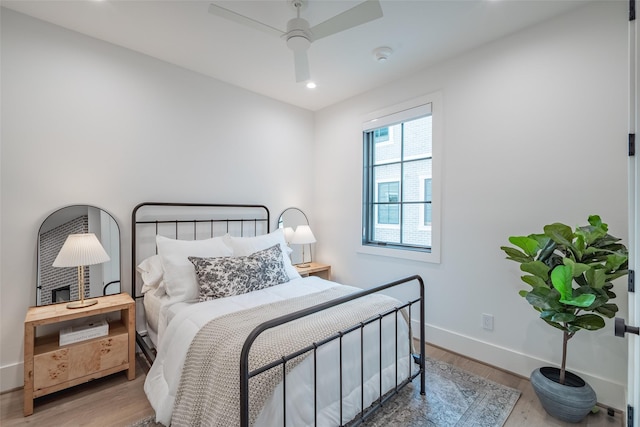 bedroom with hardwood / wood-style floors and ceiling fan