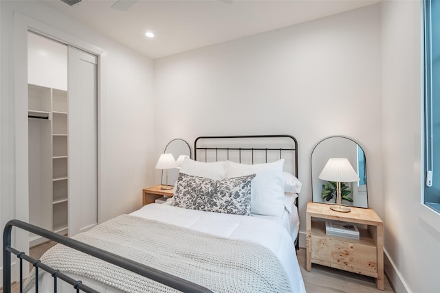 bedroom featuring light hardwood / wood-style floors and a closet