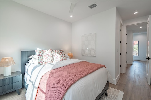 bedroom with ceiling fan and light hardwood / wood-style flooring