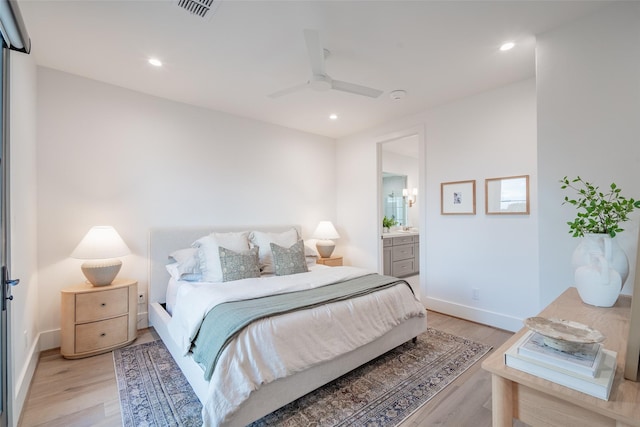 bedroom featuring ensuite bath, light hardwood / wood-style floors, and ceiling fan