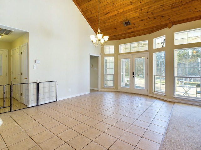 spare room with light tile patterned flooring, wooden ceiling, high vaulted ceiling, and french doors