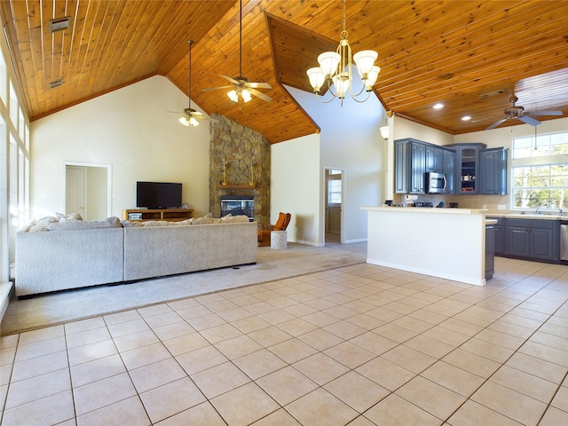 unfurnished living room with wood ceiling, light tile patterned flooring, and high vaulted ceiling