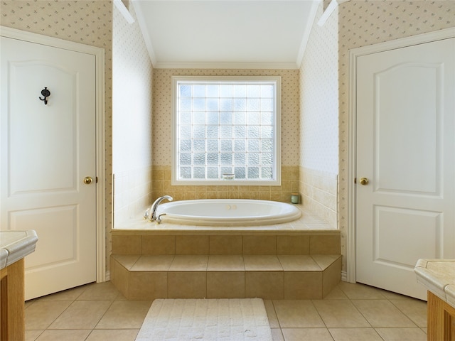 bathroom featuring vanity, tile patterned flooring, crown molding, and a relaxing tiled tub