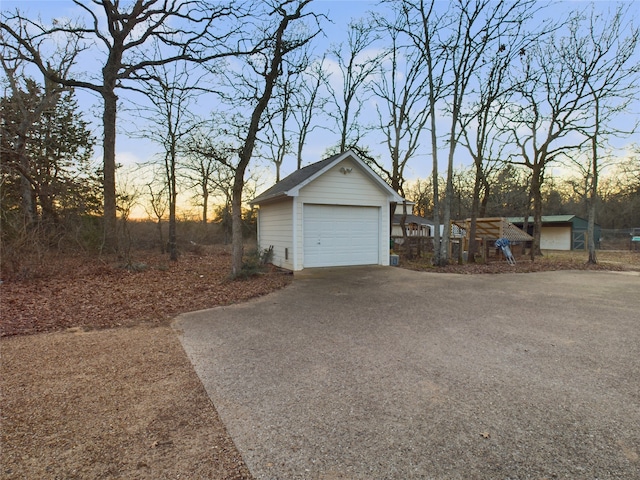 view of garage at dusk