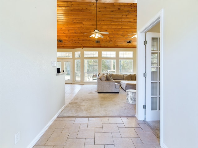 unfurnished living room featuring light tile patterned floors, wooden ceiling, and ceiling fan