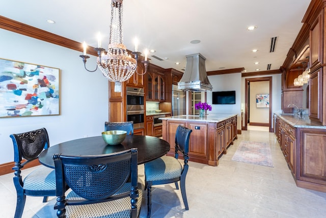 kitchen featuring crown molding, an island with sink, pendant lighting, island exhaust hood, and stainless steel double oven