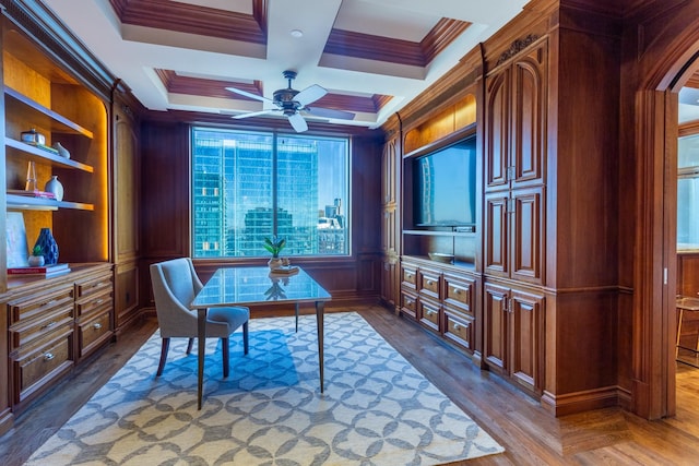 office space with coffered ceiling, ceiling fan, crown molding, and built in shelves