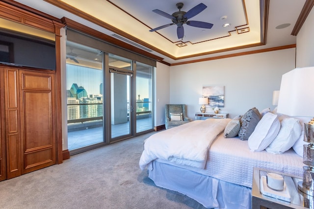 bedroom with crown molding, light colored carpet, access to outside, a tray ceiling, and ceiling fan