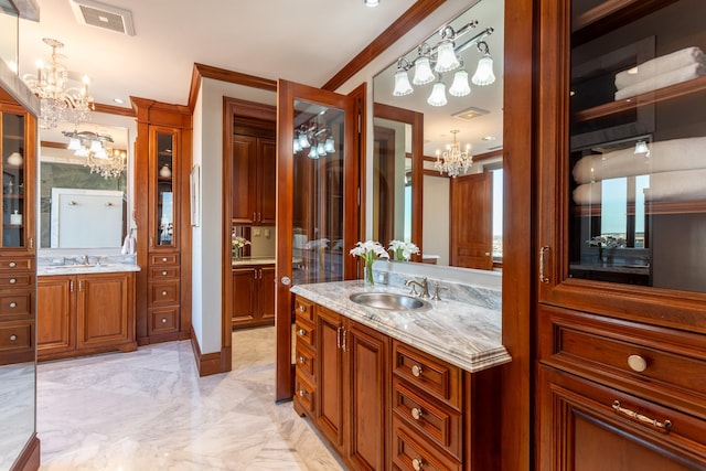 bathroom featuring vanity, a notable chandelier, and ornamental molding