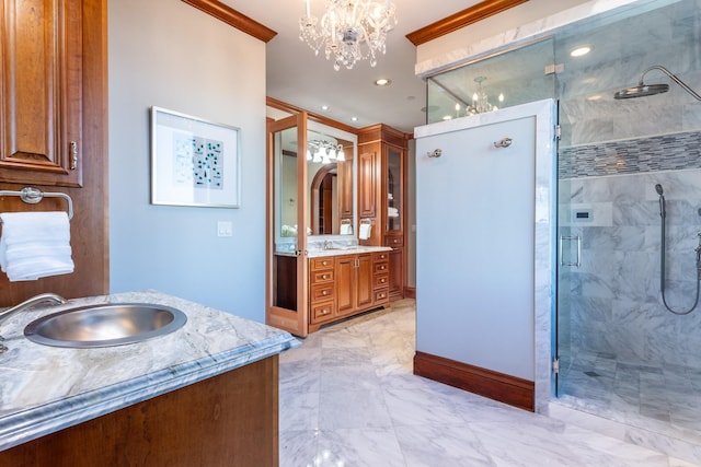 bathroom with vanity, ornamental molding, an enclosed shower, and an inviting chandelier