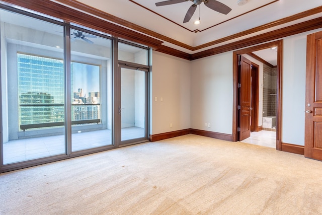 carpeted spare room featuring ornamental molding and ceiling fan