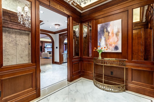 hallway featuring ornamental molding and wood walls