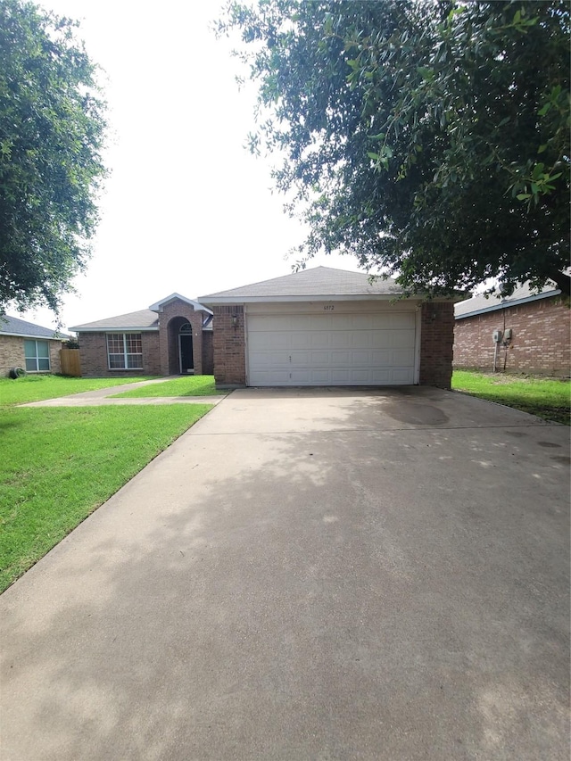 ranch-style house with a garage and a front yard