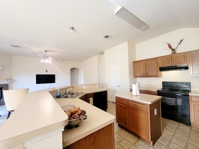 kitchen featuring sink, black electric range, ceiling fan, and a center island with sink