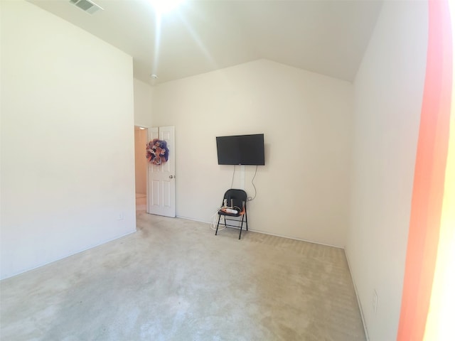 unfurnished living room featuring lofted ceiling and light carpet