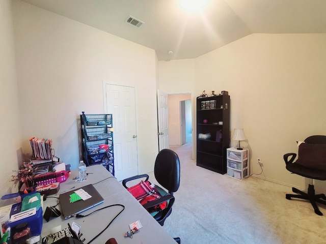 carpeted home office featuring lofted ceiling