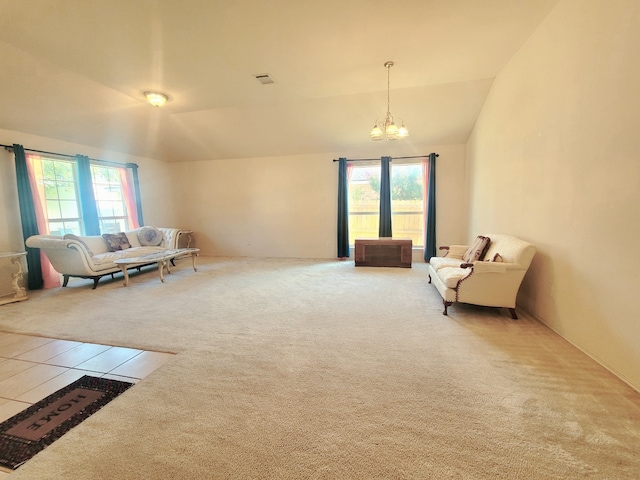 sitting room with lofted ceiling, carpet flooring, and a notable chandelier