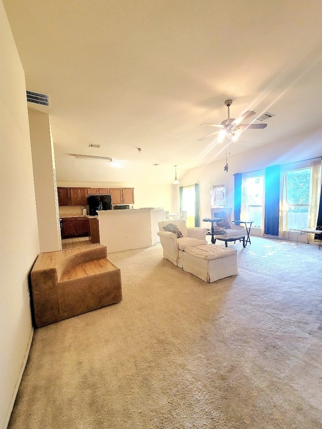 carpeted living room with ceiling fan