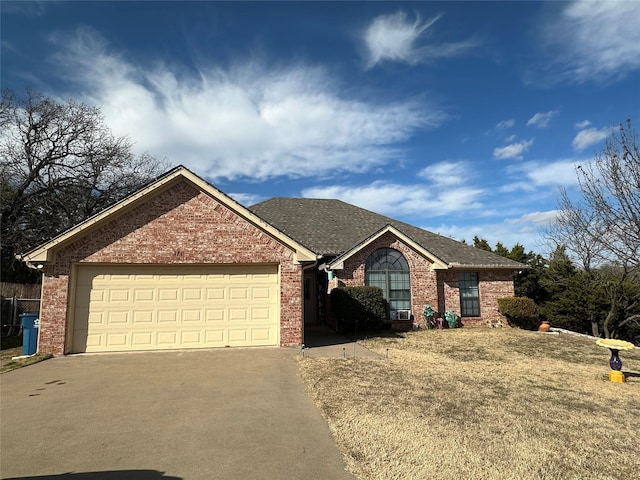 single story home featuring a garage and a front yard