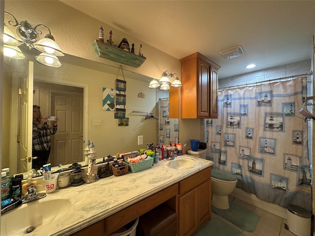 bathroom featuring tile patterned floors, toilet, and vanity