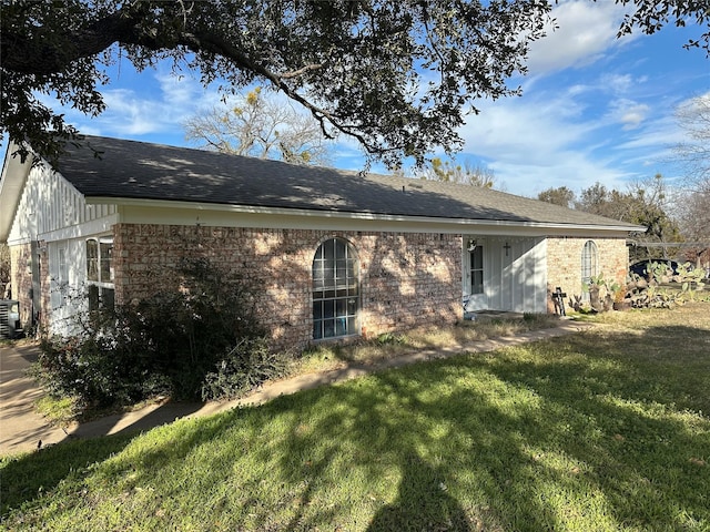 back of property with cooling unit and a yard