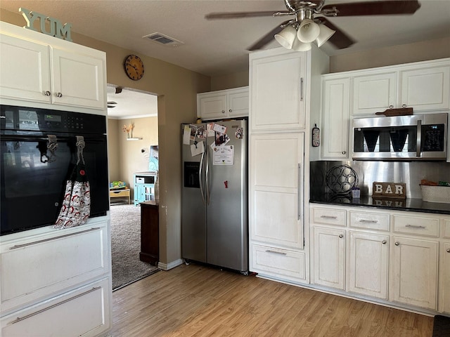 kitchen with ceiling fan, stainless steel appliances, white cabinets, and light wood-type flooring